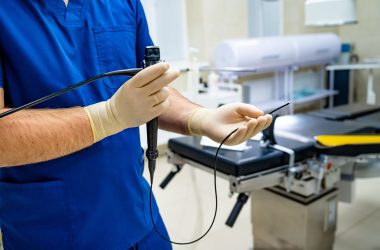 Doctor holds stethoscope in his hands in the operating room. Doctor holds stethoscope in his hands in the operating room.